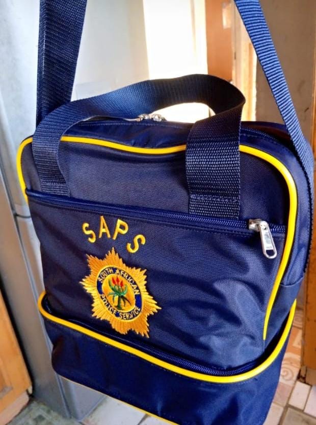 Blue school bag with yellow trim and embroidered crest
